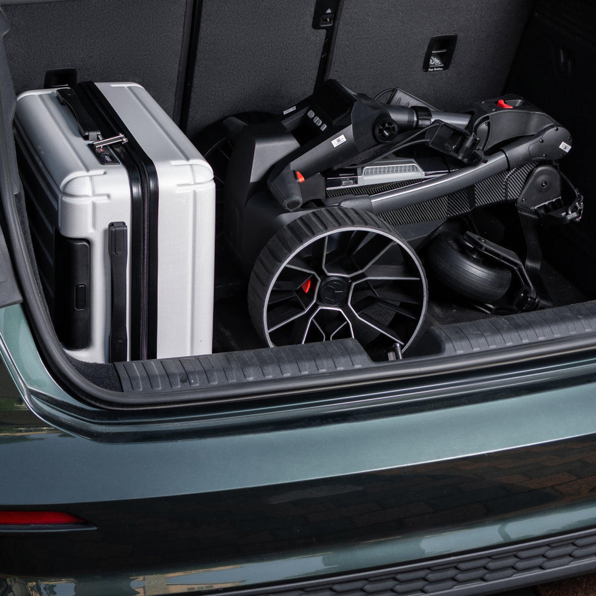 Birdie 3X folded and loaded in a car trunk