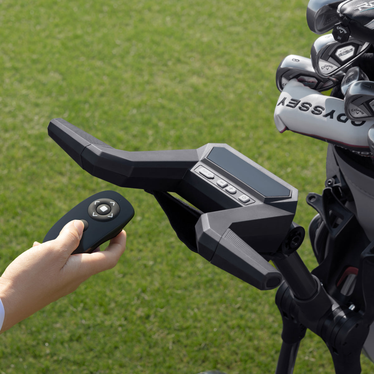 Remote control in hand beside the Birdie 3X handlebar